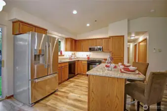 Gourmet kitchen boasts new stainless appliances and gleaming granite.