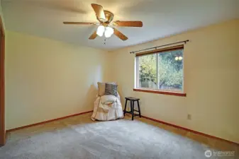 Bedroom. Rear garden view. Ceiling fan with remote. Supplemental wall heat.