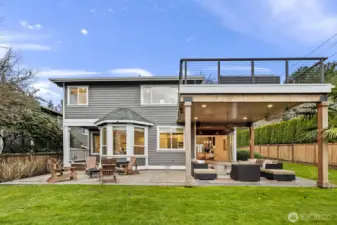 The covered patio is equipped with heaters, a fire pit and a TV (all included in the sale) and flows easily onto the sun-drenched portion of the patio for year-round enjoyment rain or shine.