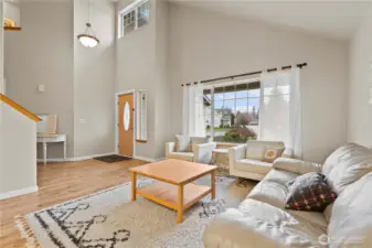 Step into a light-filled living space, where a welcoming foyer and soaring vaulted ceilings create an open, airy first impression.