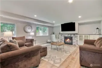 Large Bonus room downstairs with built-in cabinets & gas fireplace, new vinyl plank flooring