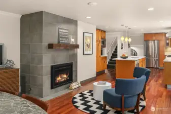 Stunning custom grey tile fireplace is a modern touch to the more traditional design elements, and provides a quiet respite to an other wise busy room.