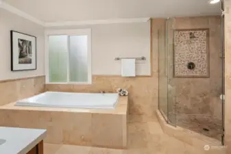 Large and elegant soaking tub, perfect for relaxing. Tiled shower is oversized as well.