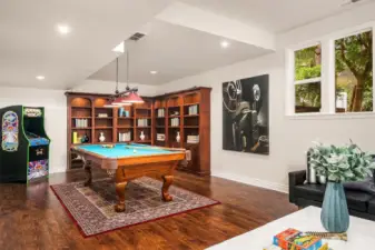 Lower level bonus room and custom, solid maple bookcase shelving unit that conveys.