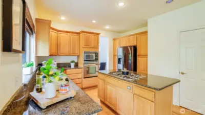This kitchen offers abundant storage with a walk in pantry and extensive cabinetry.