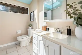 Main floor bathroom with skylight and laundry chute