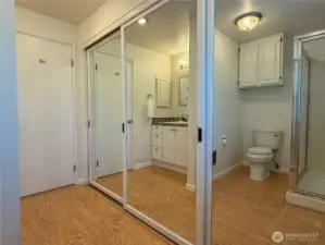 Primary bathroom has a wonderful wall of closets and storage.