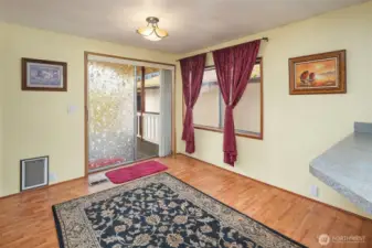 Kitchen eating area off with slider to covered patio in backyard