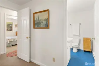 Primary half bath with a view to the 2nd bedroom.
