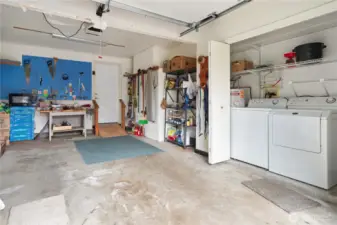 Garage is a large attached single garage with a workbench and washer/dryer.