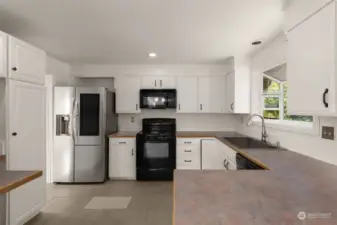 Lovely kitchen that looks out to the pool area.