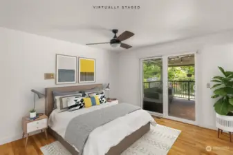 Primary bedroom with 3/4 bathroom, hardwood flooring, and a slider out to the deck.