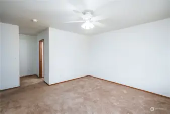 Primary bedroom with closet around the corner