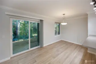 Dining area with slider to private patio with outdoor storage.