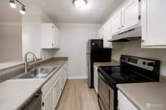 Updated kitchen with stainless appliances and new flooring and paint.