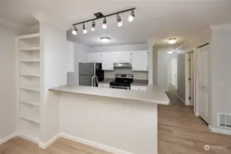 Spacious dining area adjacent to the kitchen with built in bookshelves.