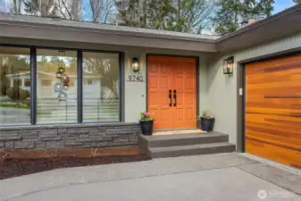 From the moment you arrive, you’re greeted by a bold terracotta-hued front door—a striking, sun-warmed statement that hints at the curated beauty within.