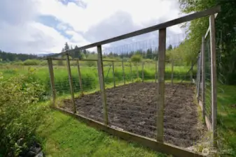 Huge fenced garden area for your vegetables or flower garden comes with rototiller.