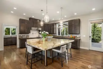 The chef’s kitchen is a culinary showpiece, boasting an oversized island, premium appliances, and an adjoining catering kitchen with a walk-in pantry, making hosting effortless and memorable.