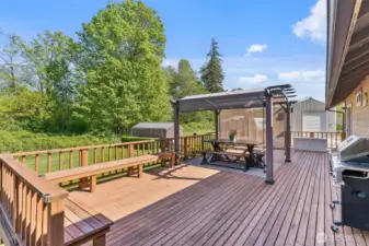 Enjoy the Spring on this deck with built in seating and pergola that stays with the home.