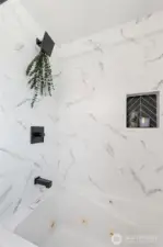 Newly tiled shower/tub enclosure in main bath.