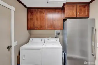 Laundry room with freezer and plenty of cabinets