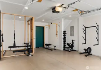 One car garage with pre-framed sauna space.  Wired for an electric sauna heater. Home gym equipment is virtually staged.