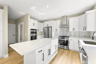 This kitchen boasts a stove/oven with a grill on top and a wall oven and microwave.