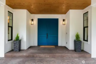 This beautiful covered entry way leads the stunning double front doors.