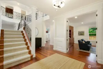 Formal entry leads to an open staircase. Having this staircase, landing, and 2-story opening to a skylight allows for consistent natural light - even on the darkest of days.