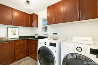 The upstairs laundry room (plus two additional full baths) completes the upstairs. Look at that storage! Washer and Dryer are almost new.