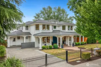 There is never a shortage of parking. Three garages out back and this huge gated driveway. The Hummingbird gates are beautiful!