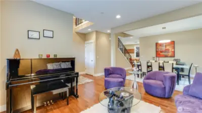 Formal living room is open to dining room with maple hardwood floors flowing throughout.