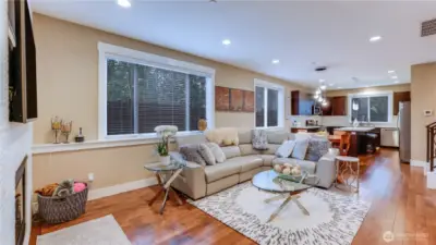Open & light family room with custom tile, gas fireplace surround, maple hardwood floors throughout.
