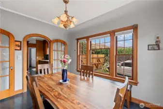 The 1928 Tudor features a formal dining room, with its mahogany wood trim windows and doors. Situated right off the foyer, it is the perfect entertaining space as well as a light flooded morning corner for coffee.