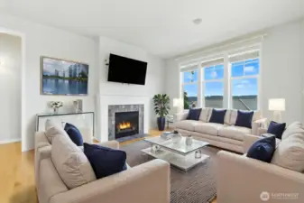 Bright and welcoming, the casual living space features large view windows and an open-concept layout that flows seamlessly into the kitchen.