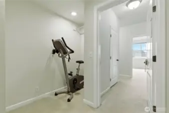 A cozy nook on the lower level is currently set up with a cycle machine but could easily be transformed into a small library, reading corner, or creative workspace.