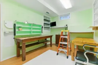 The lower-level office or workshop offers a quiet, dedicated space that could easily be converted into a podcasting room, creative studio, or any focused work area you need.