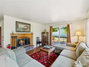 Cozy living area with real fireplace.  Slider to another deck.