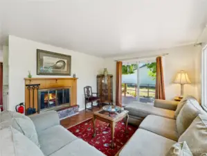 Cozy living area with real fireplace.  Slider to another deck.