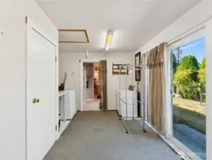 Utility room outdoor entrance from side yeard. Utility room also connects to primary bath & primary suite. This room could be converted to so many things!