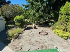 Back yard with firepit just outside of primary bedroom.