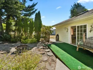 Back yard leads to primary bedroom, gate to driveway and carport.