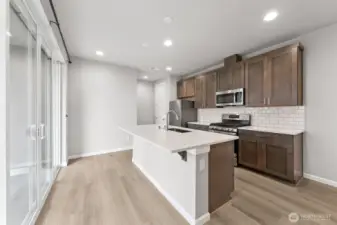 Large sliding door makes it easy to get to the covered patio for the BBQ area.