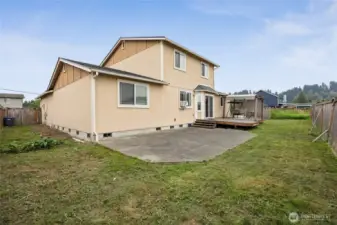 Back yard with patio, and deck with a pergola style cover.