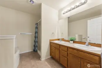 Primary bath with dual sinks, tub, and separate stand up shower.
