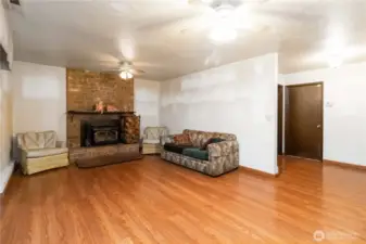 Spacious lower-level family room with warm flooring—perfect for movie nights or a cozy hangout