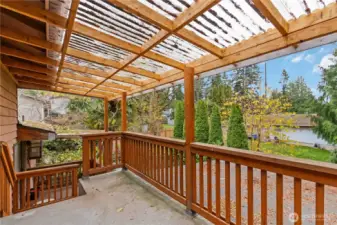 A cozy, sheltered deck space surrounded by lush greenery—perfect for relaxing anytime