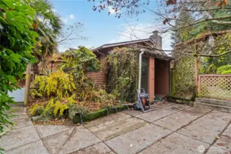 Private, low-maintenance patio surrounded by lush landscaping—ready for your outdoor vision