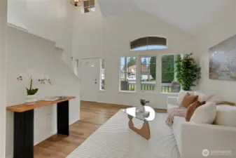 Another angle of the living room looking out the large windows to the covered porch